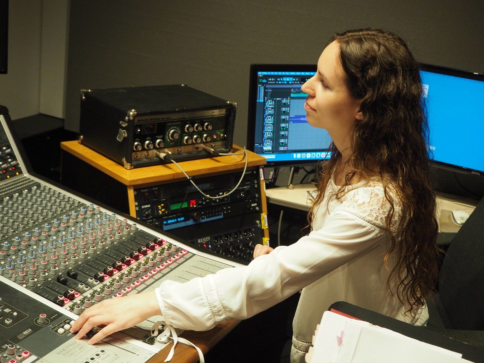 An engineer at the Audient console in the control room, Pro Tools on screen and the Roland Space Echo and Manley Massive Passive in the rack behind