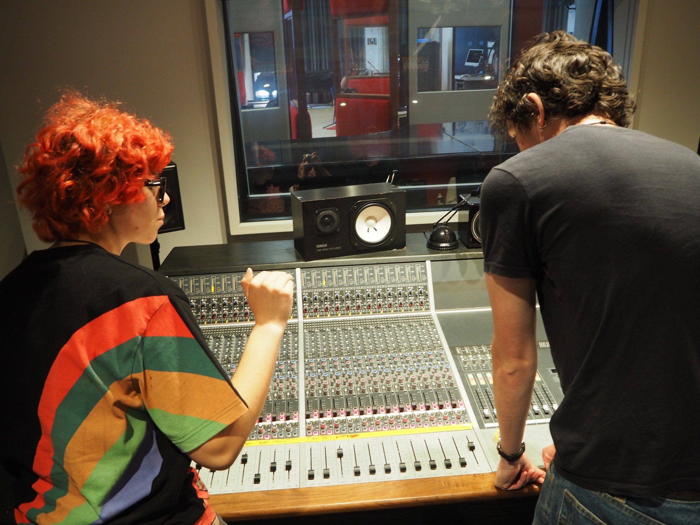 Student engineers working on the Audient console in the control room