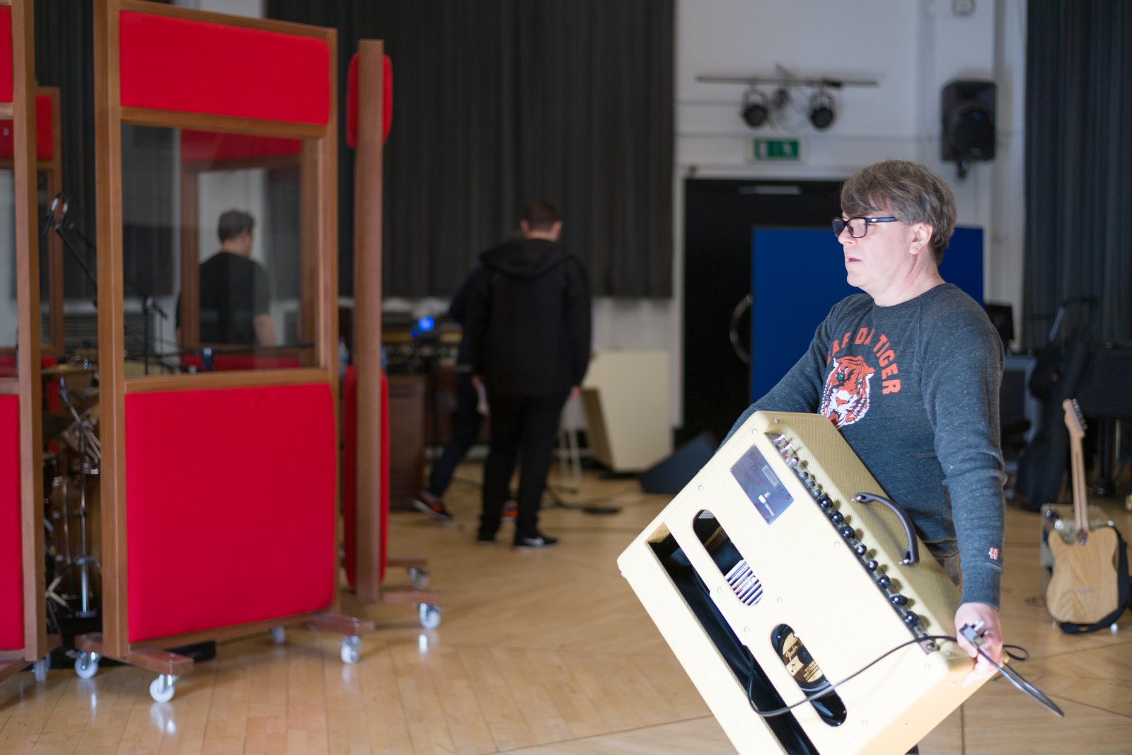 Carrying an amp across the live room while setting up a session