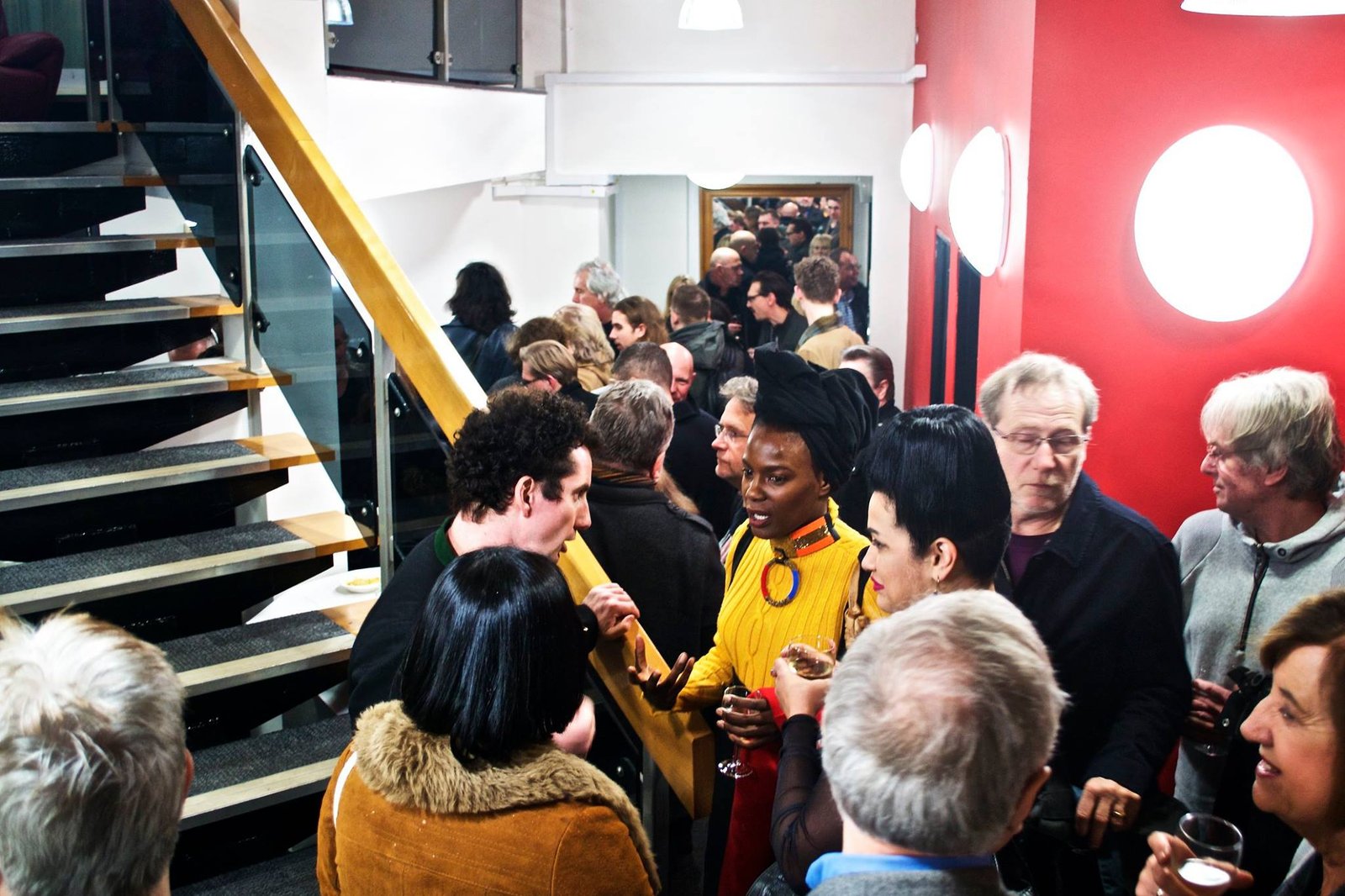 Studio foyer full of guests standing and chatting after an event