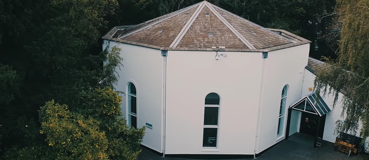 Exterior view of Visconti Studio, nestled amongst trees and greenery.